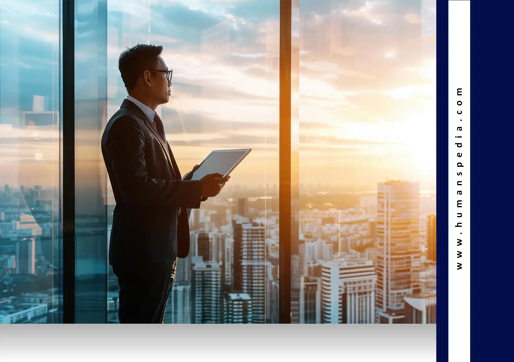 Business professional holding a tablet and overlooking a modern city skyline through tall glass windows at sunset — symbolizing leadership, strategy, and insights from a Bali Business Guide.